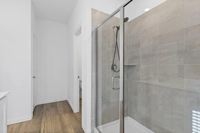 a bathroom with a shower and a glass door