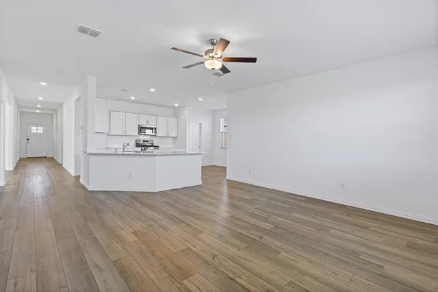 a view of a kitchen with a stove cabinets and wooden floor