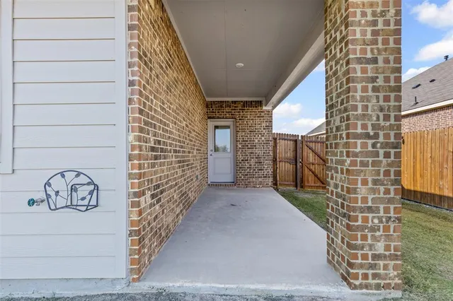 a view of a door and brick wall