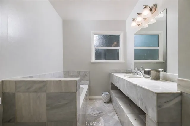 a bathroom with a double vanity sink and a mirror