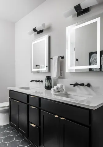 a bathroom with a sink vanity and mirror