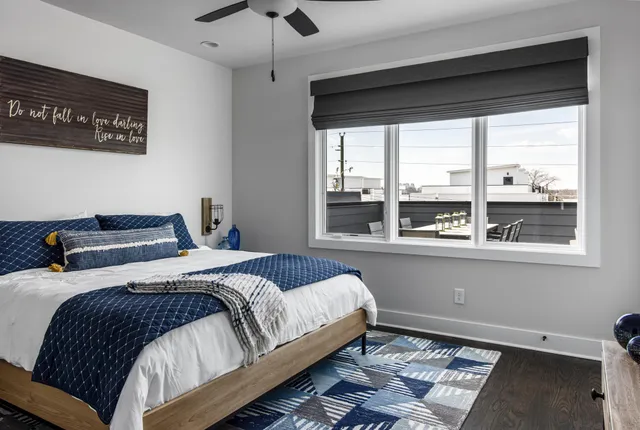 a bedroom with a bed and a large window