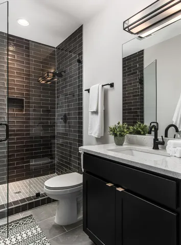 a bathroom with a sink toilet and shower
