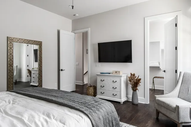 a bedroom with a bed and a flat screen tv