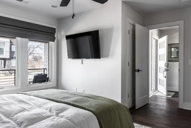 a bedroom with a bed and a flat screen tv