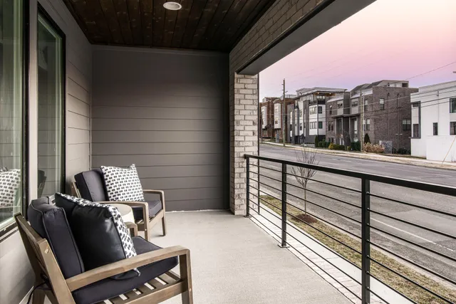 a view of a chairs and table in a balcony