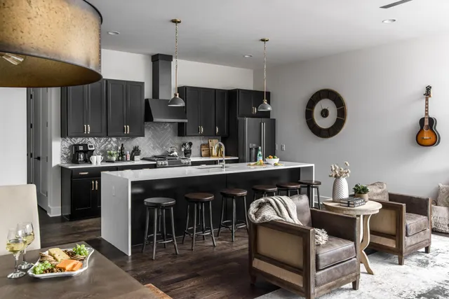 a kitchen with stainless steel appliances granite countertop a sink a stove and a refrigerator