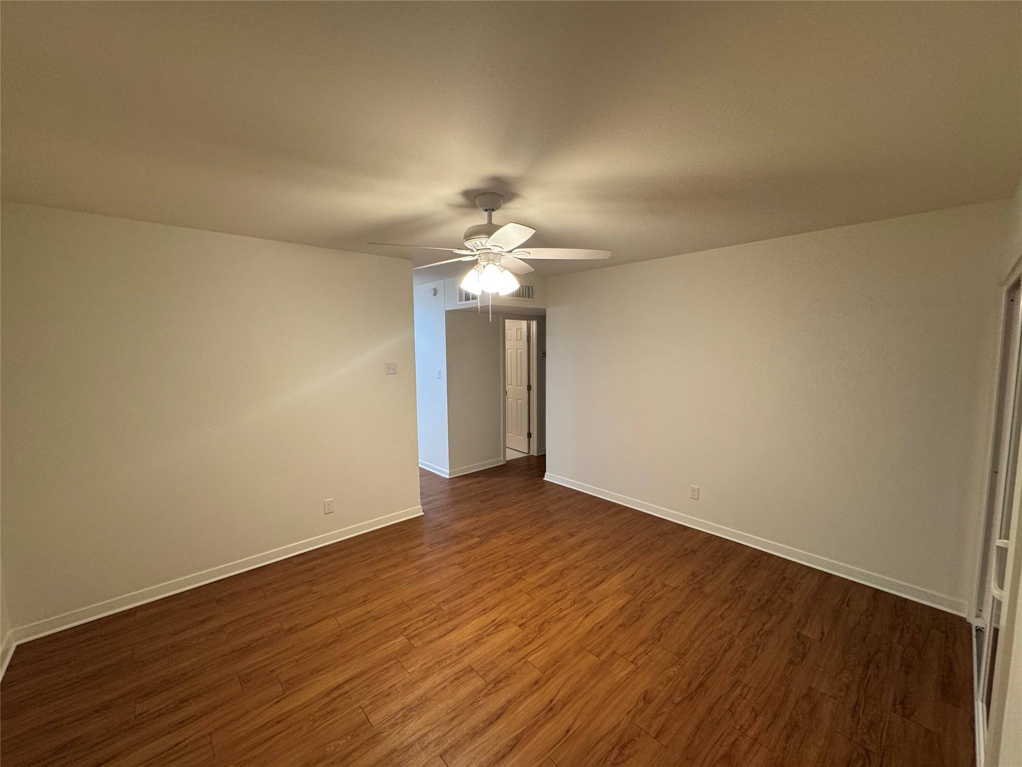 2514 West 12th Street, Unit D Austin, TX 78703 - Photo 10 of 11 a view of a room with wooden floor and a ceiling fan