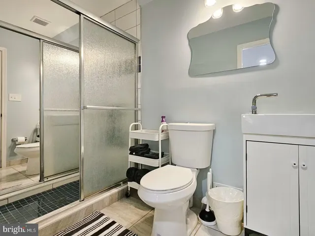 a bathroom with a toilet and a shower