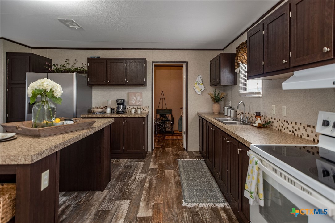 1849 Royal Road Port Lavaca, TX 77979 - Photo 19 of 40 a kitchen with stainless steel appliances granite countertop a sink stove and refrigerator