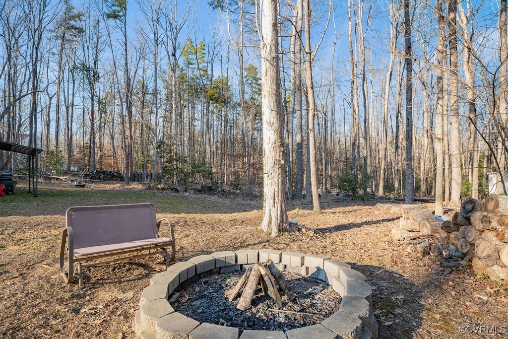 4360 Worsham Road Powhatan, VA 23139 - Photo 26 of 30 View of yard featuring an outdoor fire pit