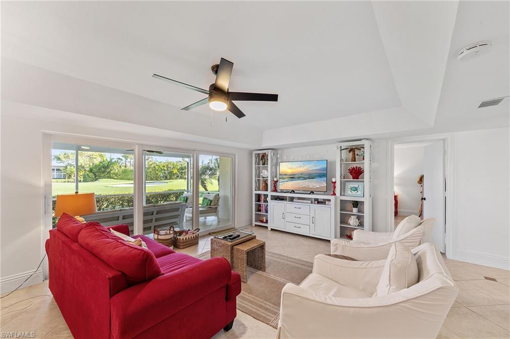 171 Quails Nest Road, Unit 3 Naples, FL 34112 - Photo 12 of 50 a living room with furniture and a large window