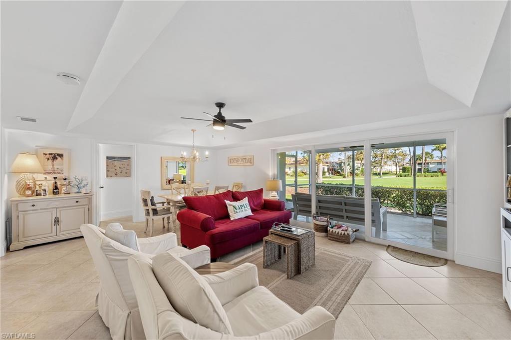 171 Quails Nest Road, Unit 3 Naples, FL 34112 - Photo 13 of 50 a living room with furniture and a floor to ceiling window