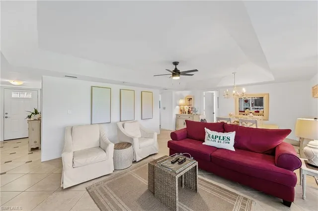 a living room with furniture and a ceiling fan