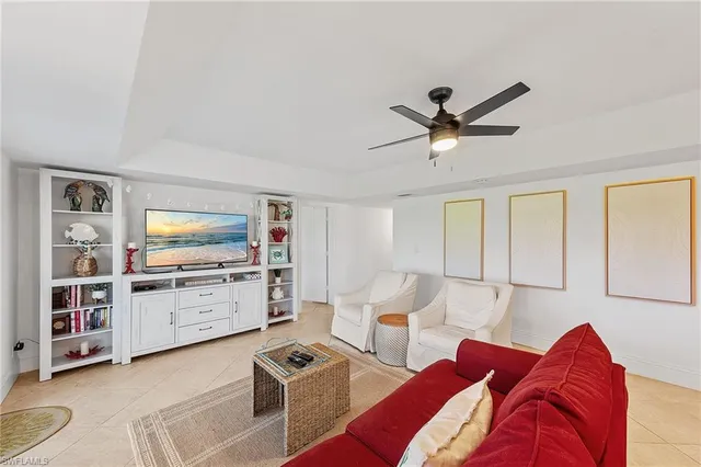 a living room with furniture and view of kitchen