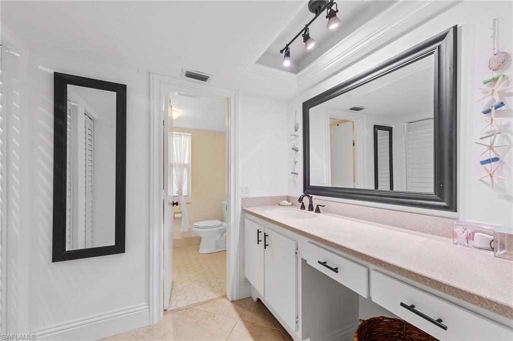 171 Quails Nest Road, Unit 3 Naples, FL 34112 - Photo 24 of 50 a spacious bathroom with a double vanity sink and a mirror