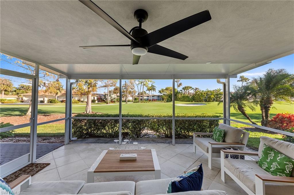 171 Quails Nest Road, Unit 3 Naples, FL 34112 - Photo 30 of 50 a living room with patio furniture and a floor to ceiling window
