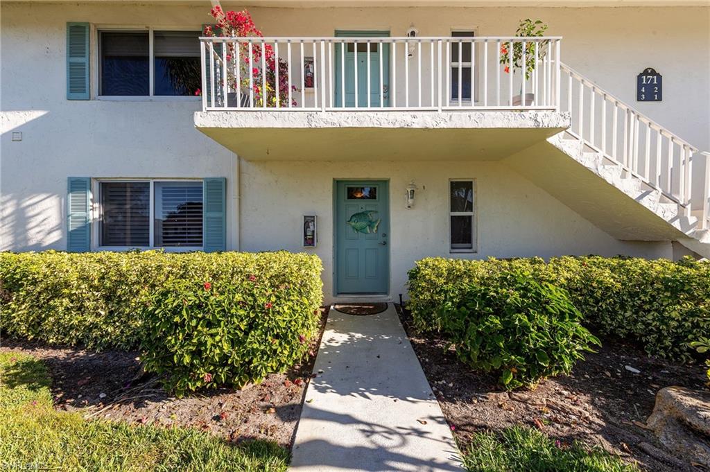 171 Quails Nest Road, Unit 3 Naples, FL 34112 - Photo 3 of 50 a front view of a house with a yard