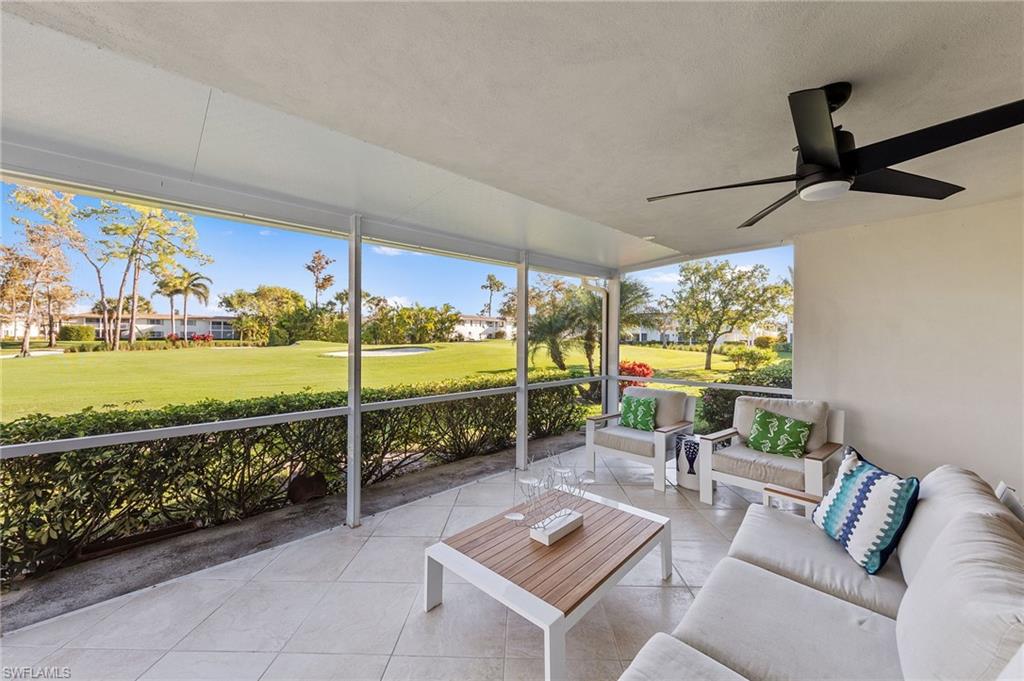171 Quails Nest Road, Unit 3 Naples, FL 34112 - Photo 32 of 50 a living room with furniture and a floor to ceiling window