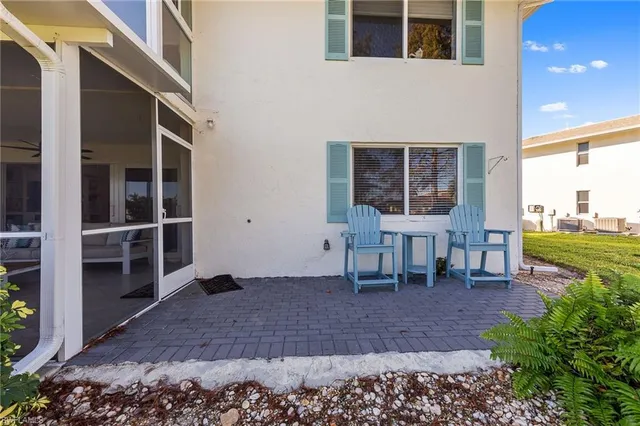 a view of a house with backyard porch and sitting area