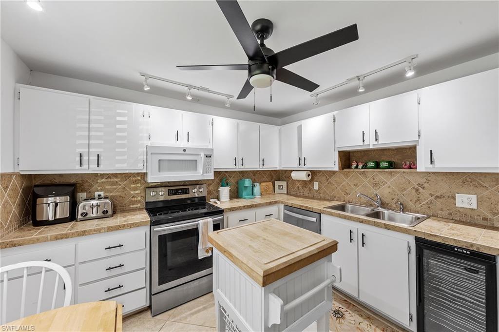 171 Quails Nest Road, Unit 3 Naples, FL 34112 - Photo 7 of 50 a kitchen with stainless steel appliances granite countertop a stove a sink and a refrigerator