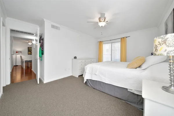 a spacious bedroom with a bed and a chandelier