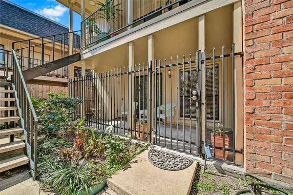 a view of a door with a bench and potted plant