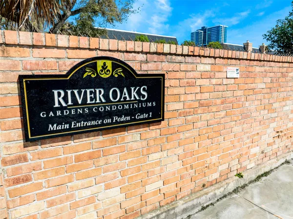 a street sign on a wall next to a road