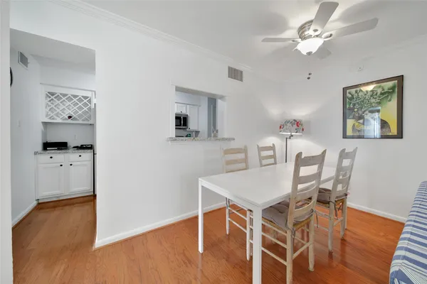 a view of a dining room with furniture and wooden floor