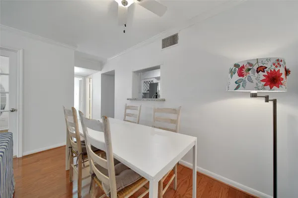 a view of a dining room that has a table and chairs in it