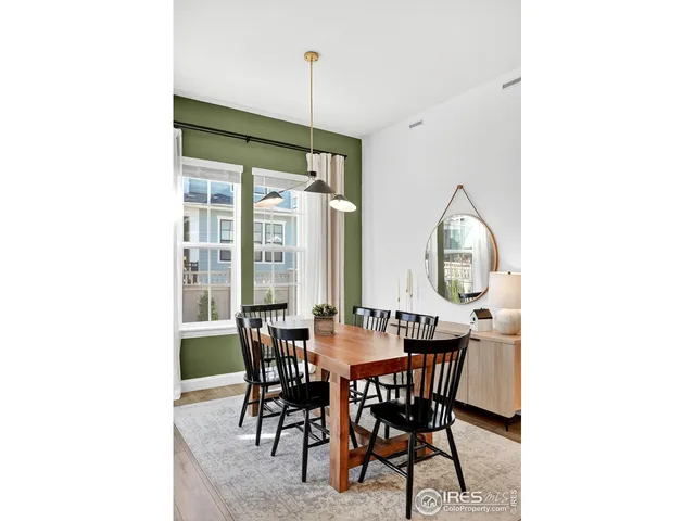 a open kitchen with stainless steel appliances granite countertop a stove top oven a refrigerator a sink dishwasher and white cabinets with wooden floor