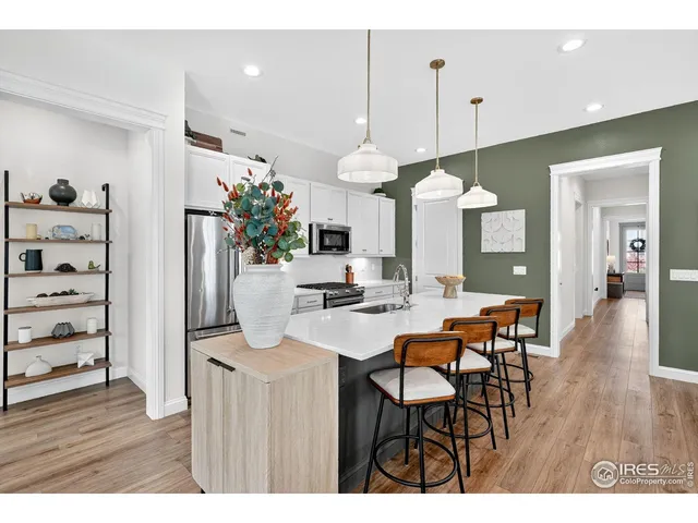 a kitchen with kitchen island a sink stove and refrigerator