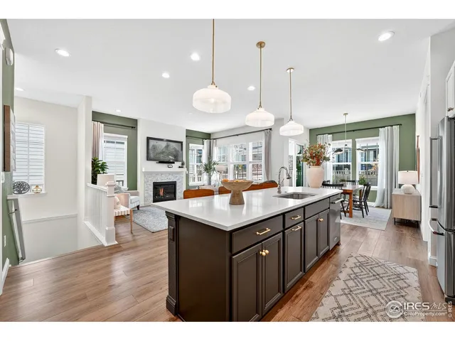 a kitchen with stainless steel appliances granite countertop a sink a stove and a refrigerator