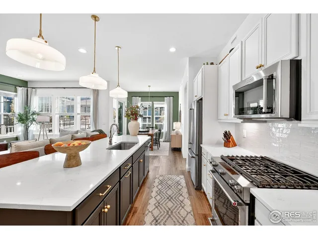 a kitchen with stainless steel appliances a stove and microwave