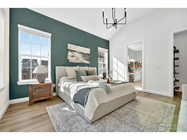 a bedroom with furniture and a large mirror