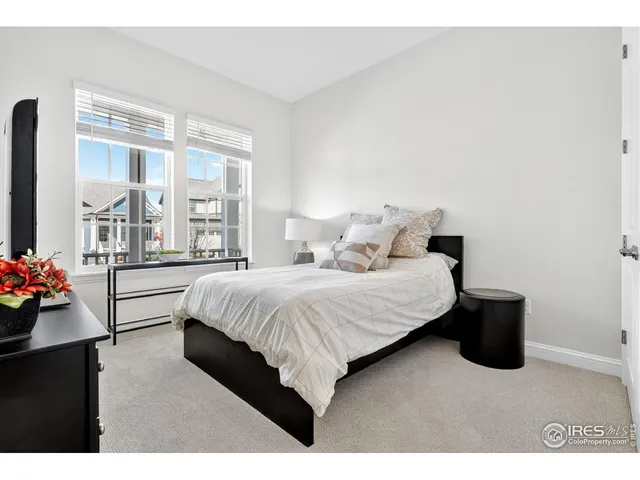 a bedroom with a bed and a potted plant