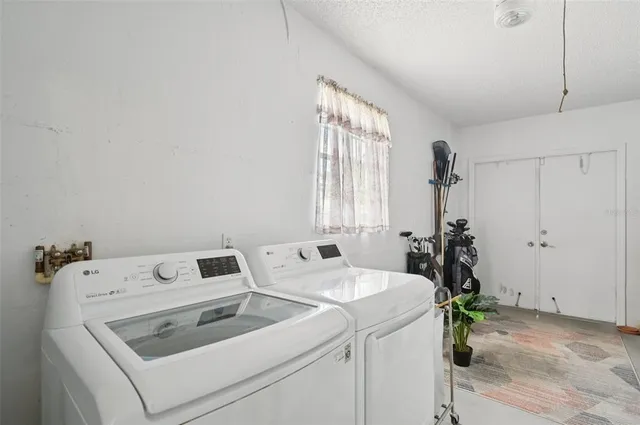 a backyard of a house with potted plants and wooden fence