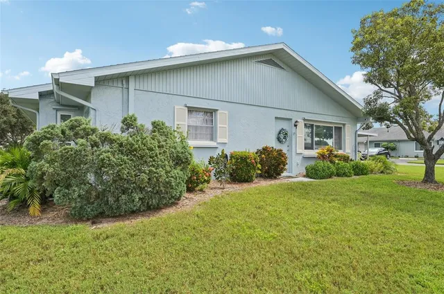 an aerial view of residential houses with outdoor space and street view