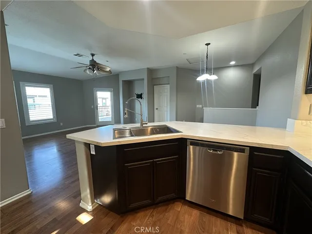 a kitchen with a sink and chandelier