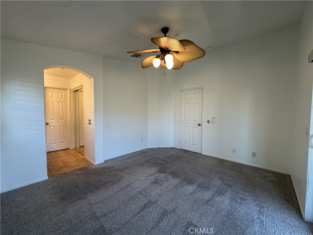 25190 Crest Haven Street, Unit 2 Murrieta, CA 92562 - Photo 16 of 30 an empty room with closet and a chandelier fan