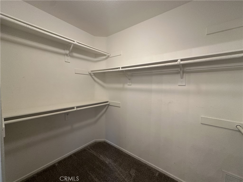 25190 Crest Haven Street, Unit 2 Murrieta, CA 92562 - Photo 21 of 30 a view of an empty walk in closet
