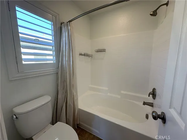 a bathroom with a toilet and a bathtub