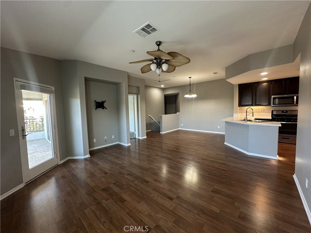 25190 Crest Haven Street, Unit 2 Murrieta, CA 92562 - Photo 7 of 30 a view of kitchen with cabinets and wooden floor