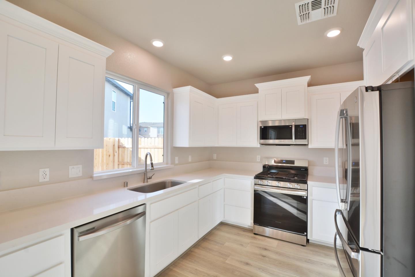 809 Big Range Way Rocklin, CA 95765 - Photo 7 of 31 a kitchen with stainless steel appliances a refrigerator sink and microwave
