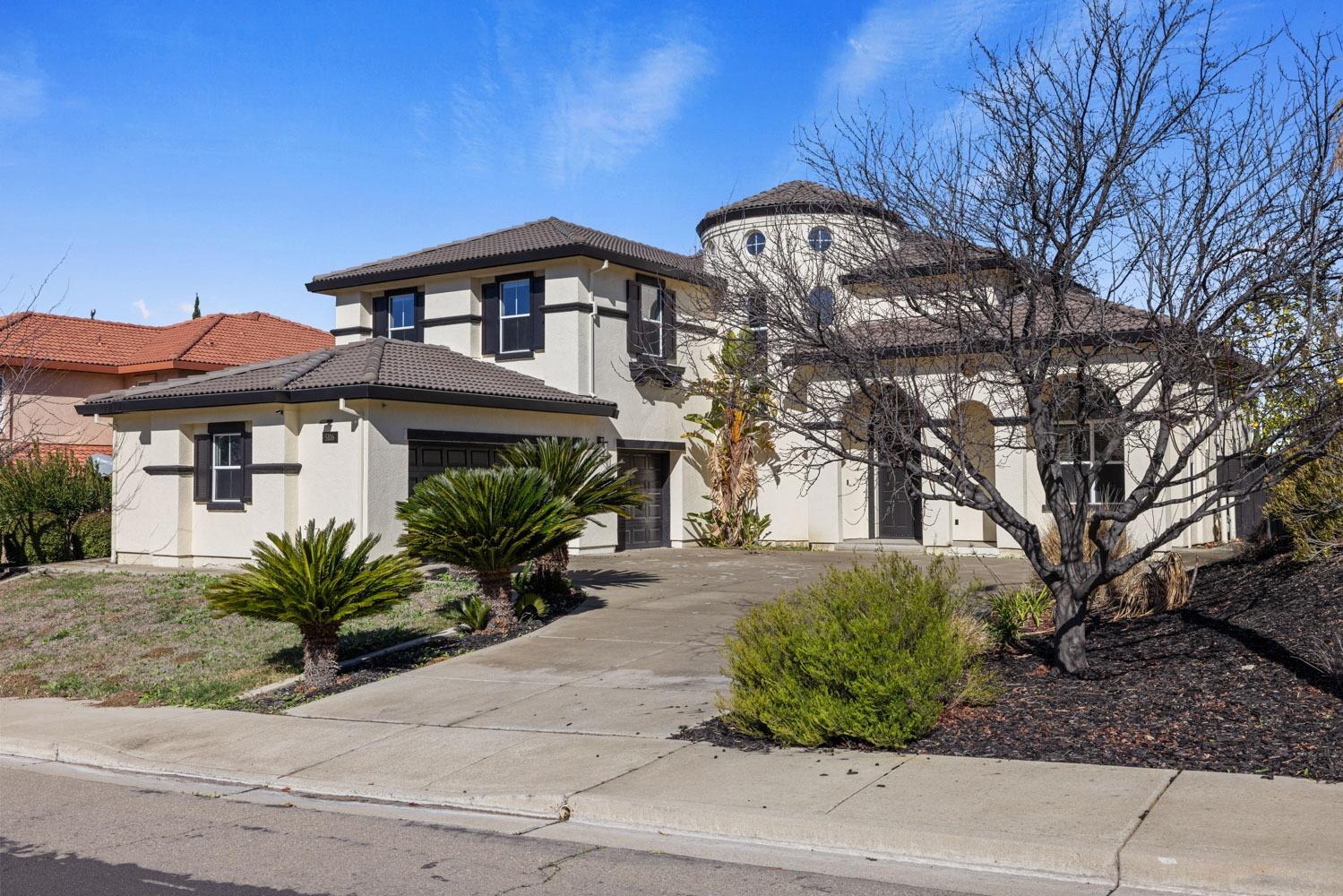 a front view of a house with a garden