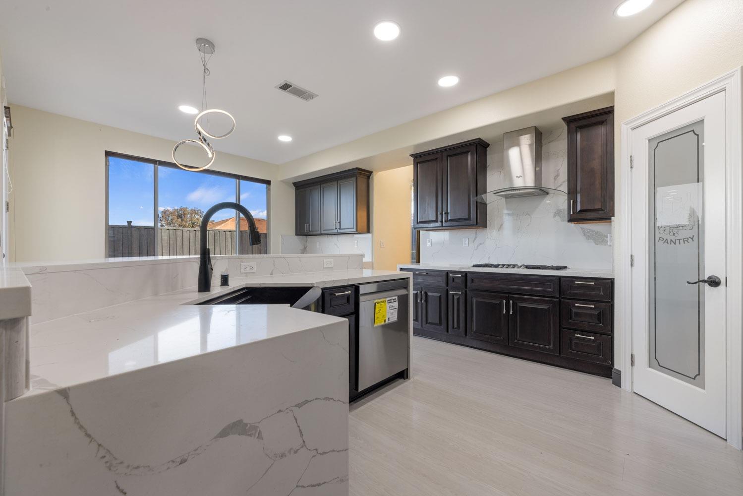 5106 Watkings Way Antioch, CA 94531 - Photo 16 of 50 a large kitchen with stainless steel appliances granite countertop a large stove top oven a refrigerator a sink and dishwasher