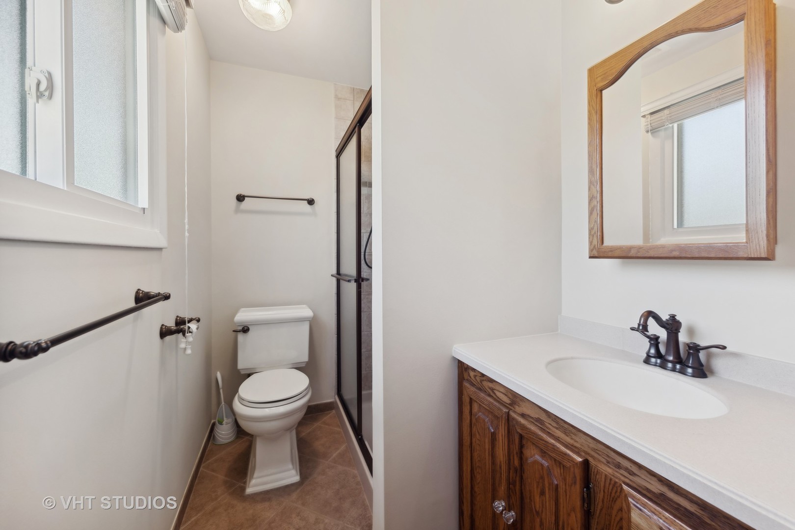 1623 South Prospect Street Wheaton, IL 60189 - Photo 14 of 26 a bathroom with a sink a toilet and a mirror