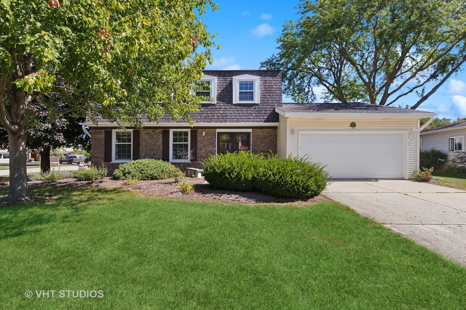 1623 South Prospect Street Wheaton, IL 60189 - Photo 2 of 26 a front view of a house with a yard and garage
