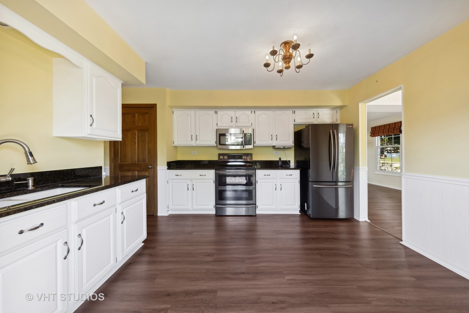1623 South Prospect Street Wheaton, IL 60189 - Photo 9 of 26 a kitchen with granite countertop white cabinets and stainless steel appliances