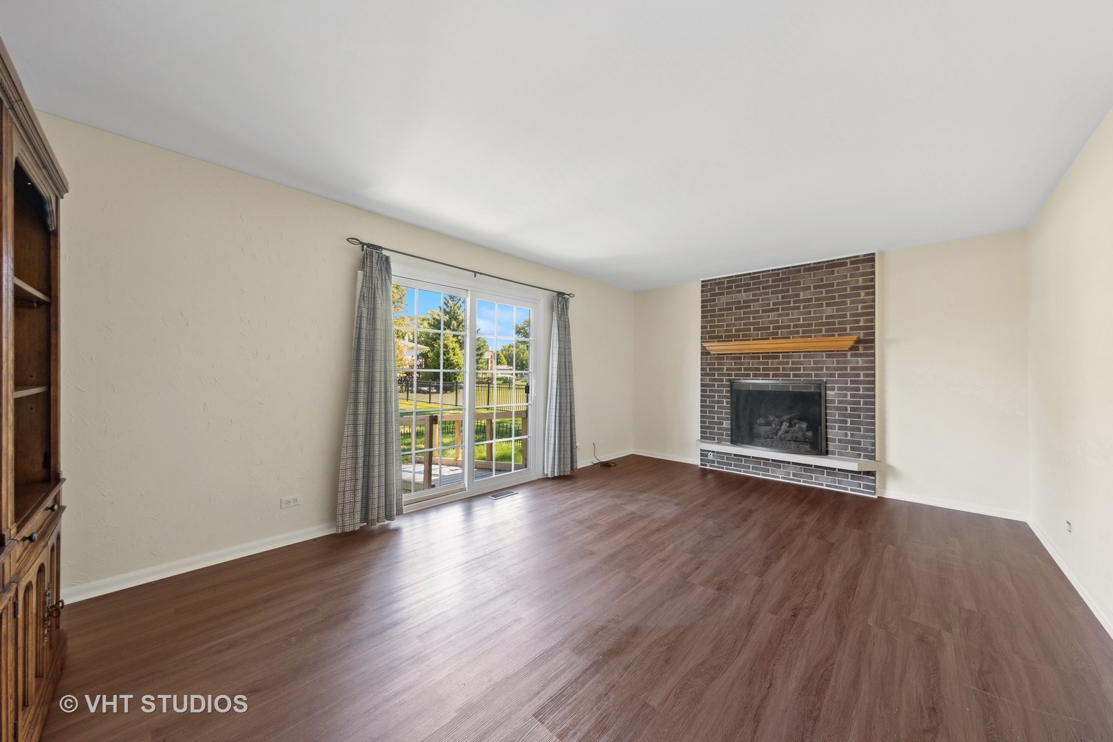 1623 South Prospect Street Wheaton, IL 60189 - Photo 10 of 26 an empty room with wooden floor and a fireplace